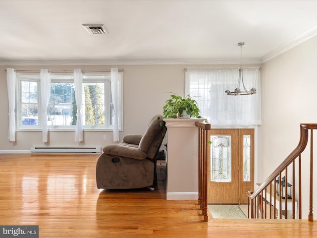 entryway featuring a baseboard radiator, an inviting chandelier, light hardwood / wood-style flooring, and ornamental molding