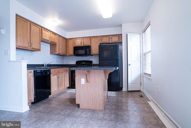 kitchen with a breakfast bar area, black appliances, and a kitchen island