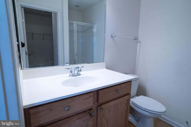 bathroom featuring walk in shower, vanity, and toilet