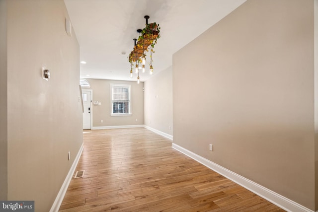 corridor with light hardwood / wood-style flooring