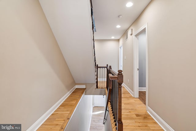 hallway with light hardwood / wood-style floors