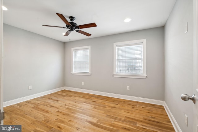 empty room with ceiling fan and light hardwood / wood-style floors