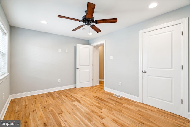 unfurnished bedroom with ceiling fan and light wood-type flooring