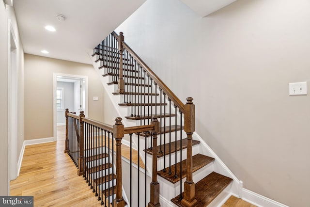 staircase featuring wood-type flooring