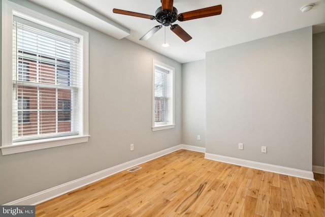 spare room with ceiling fan and light hardwood / wood-style flooring