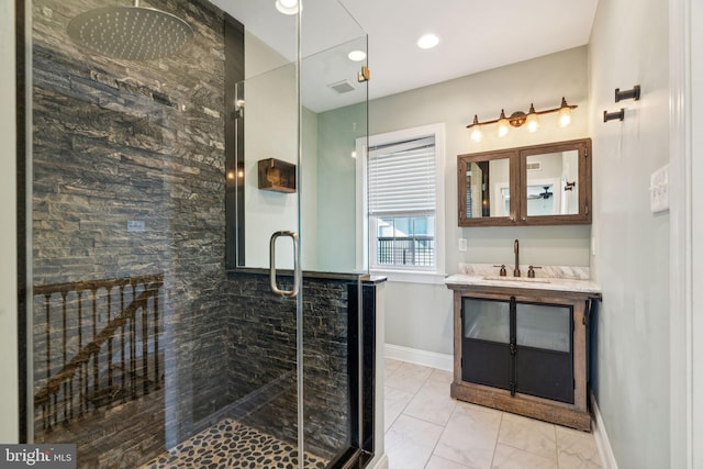 bathroom with vanity and a shower with shower door