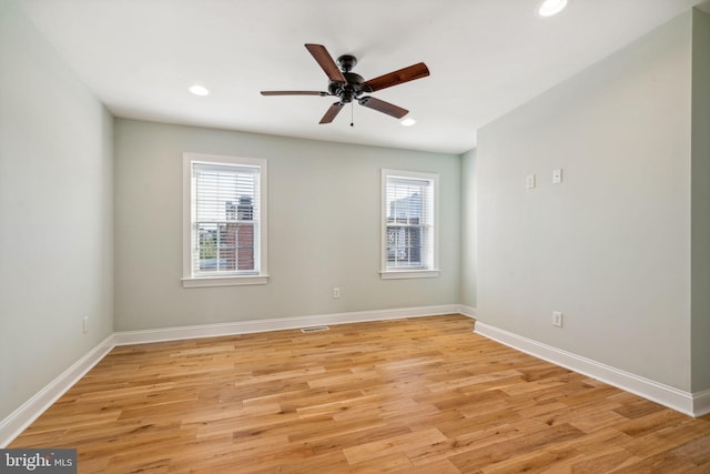 unfurnished room featuring ceiling fan, plenty of natural light, and light wood-type flooring