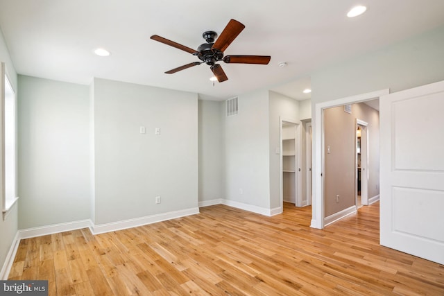 empty room featuring ceiling fan and light wood-type flooring