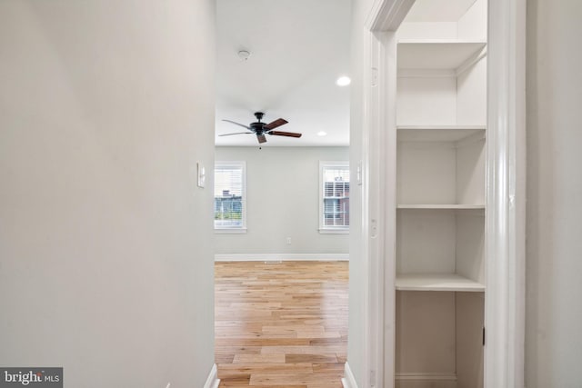 corridor with light wood-type flooring