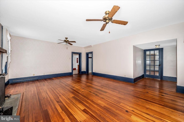 unfurnished living room with ceiling fan and dark hardwood / wood-style flooring