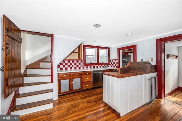 kitchen featuring tasteful backsplash, dishwasher, dark hardwood / wood-style floors, and sink