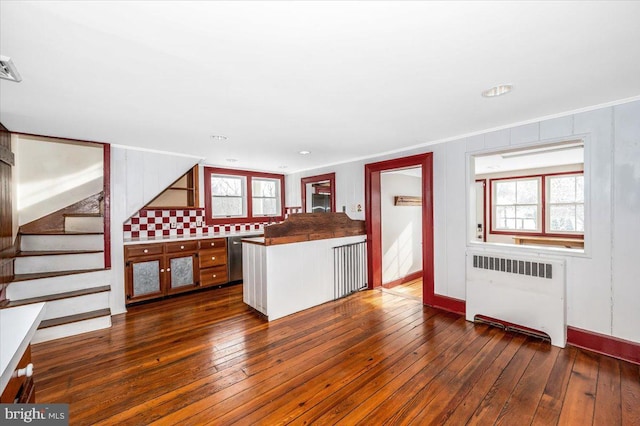 kitchen with dark hardwood / wood-style flooring, radiator, and crown molding