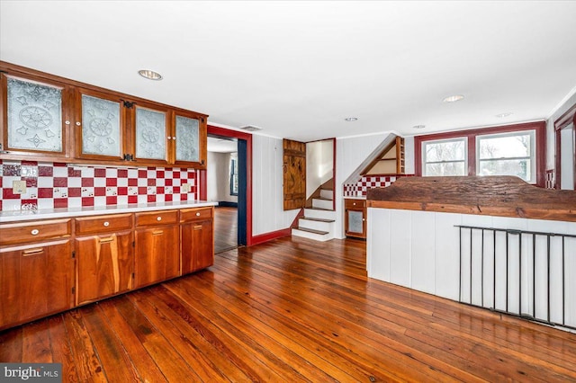 kitchen with dark hardwood / wood-style flooring and decorative backsplash