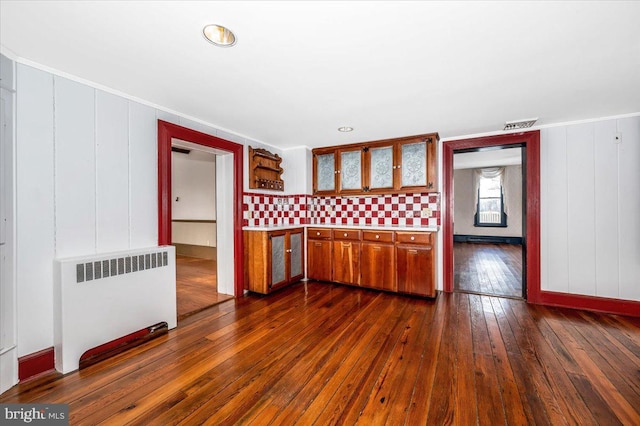 kitchen featuring crown molding, radiator, and dark hardwood / wood-style flooring