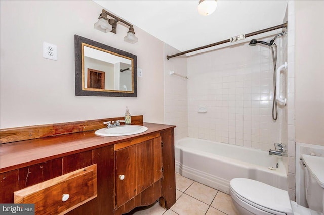 full bathroom featuring tile patterned flooring, vanity, tiled shower / bath combo, and toilet