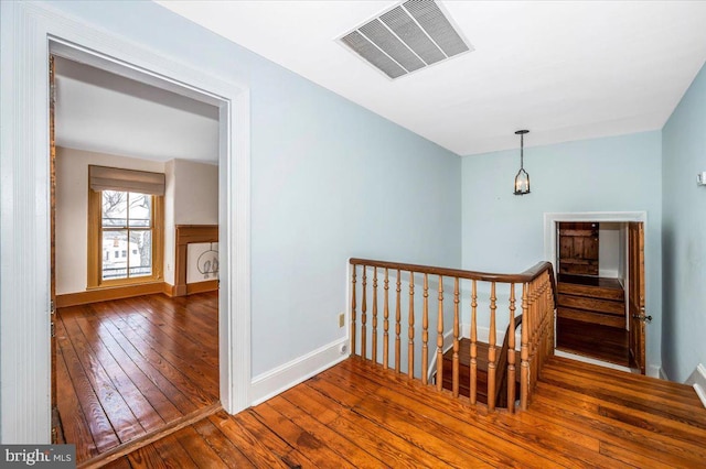 hallway with dark hardwood / wood-style flooring