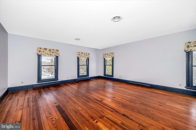 unfurnished room with dark wood-type flooring