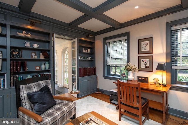 home office with coffered ceiling, beam ceiling, light hardwood / wood-style flooring, and ornamental molding