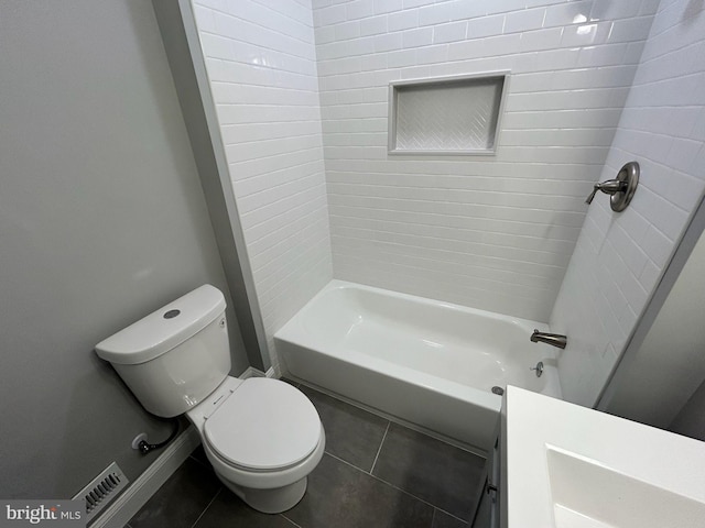 full bathroom featuring tiled shower / bath combo, toilet, tile patterned floors, and vanity