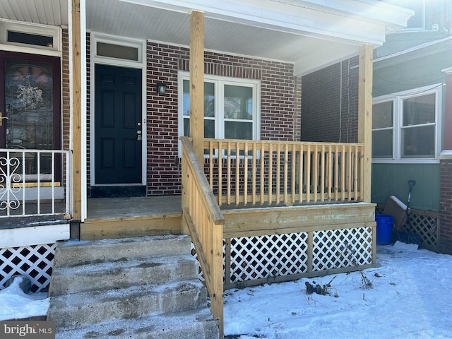 view of snow covered property entrance