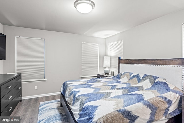 bedroom with dark hardwood / wood-style flooring