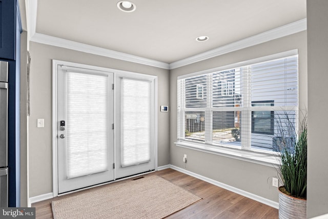 doorway to outside with crown molding and wood-type flooring