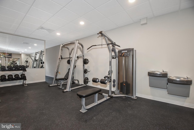 exercise room featuring a drop ceiling