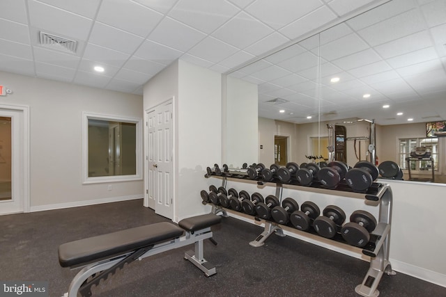 gym featuring a paneled ceiling