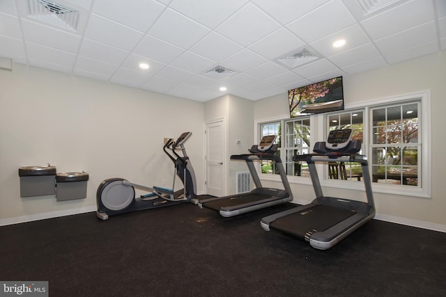 exercise room featuring a paneled ceiling