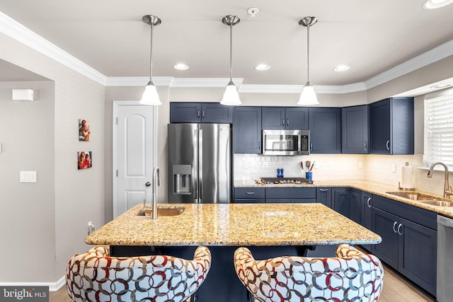 kitchen with stainless steel appliances, a center island, and sink