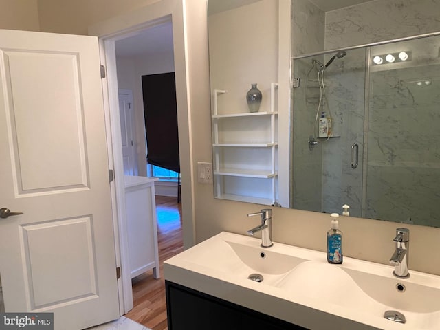 bathroom featuring vanity, hardwood / wood-style flooring, and a shower with door