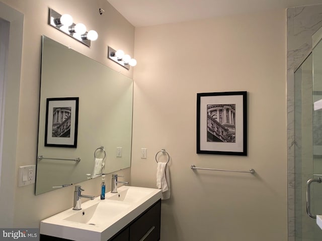 bathroom with vanity and a shower with door