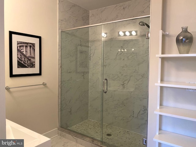 bathroom featuring a shower with door