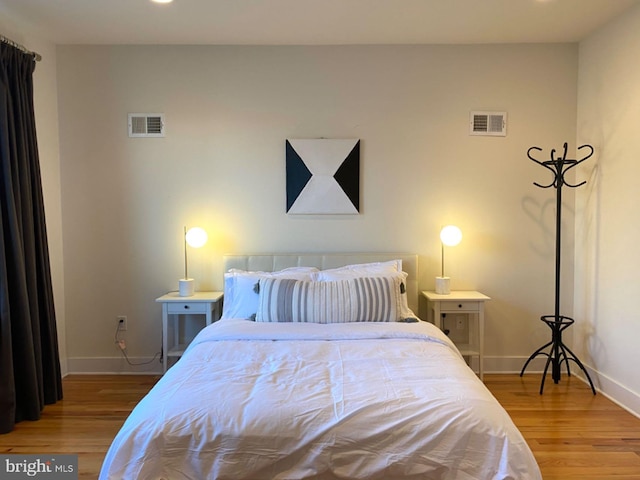 bedroom with wood-type flooring