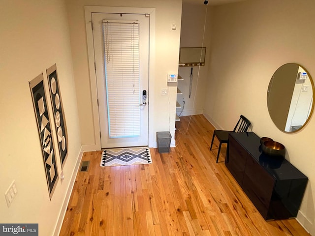 foyer entrance with light hardwood / wood-style floors