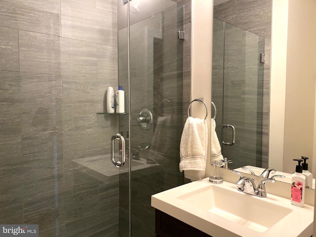 bathroom with vanity and a shower with shower door