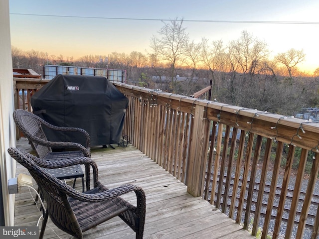 deck at dusk with a grill