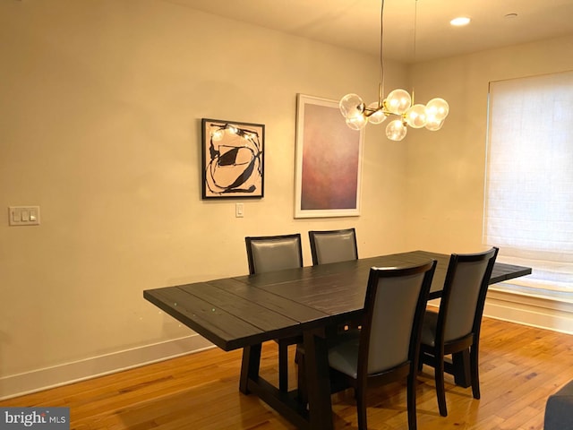 dining room featuring hardwood / wood-style flooring and a notable chandelier