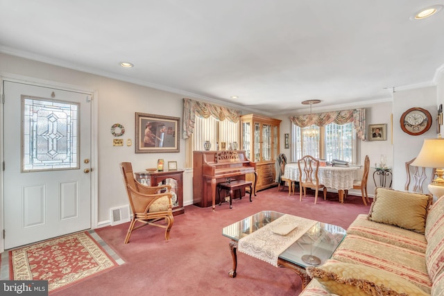 carpeted living room featuring ornamental molding and an inviting chandelier