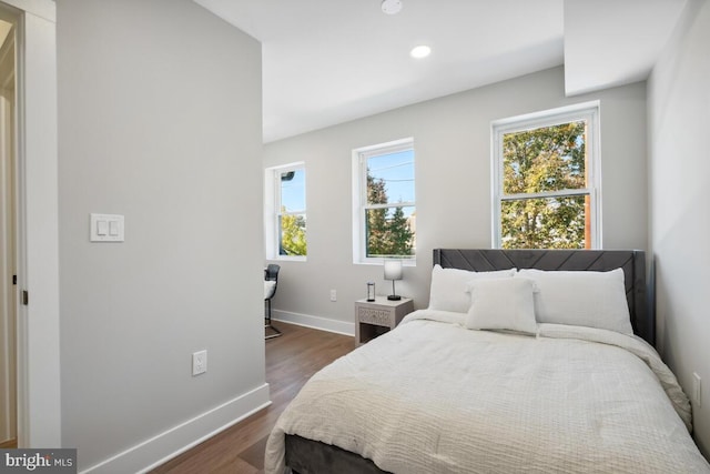 bedroom with dark hardwood / wood-style flooring