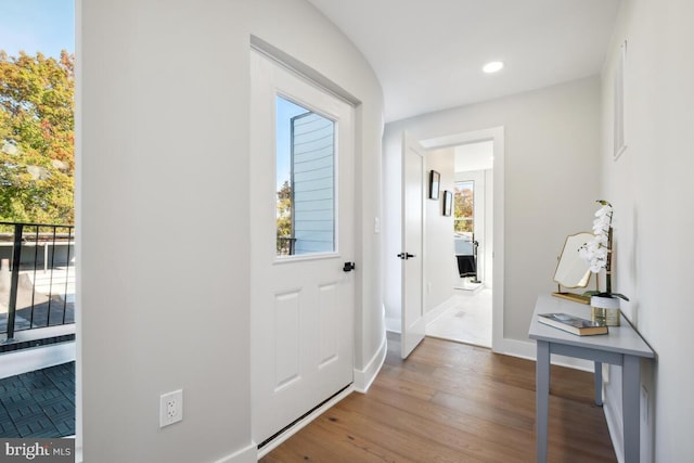 doorway to outside featuring hardwood / wood-style flooring and plenty of natural light