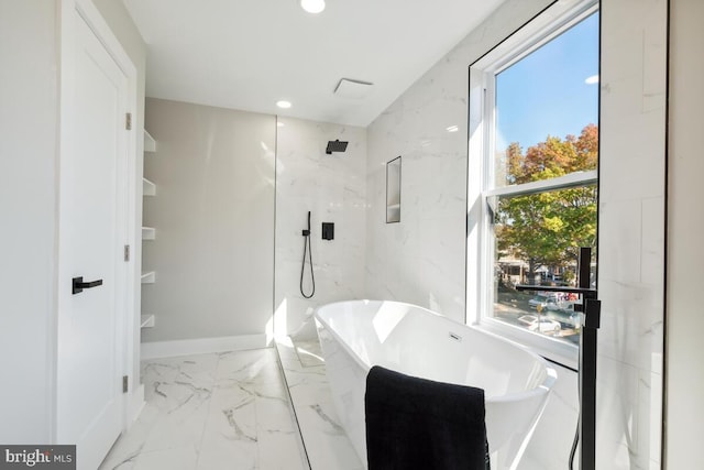 bathroom with plenty of natural light and separate shower and tub