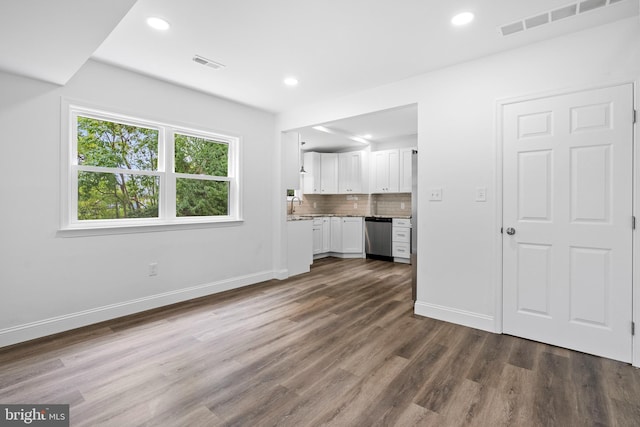 unfurnished living room with sink and dark wood-type flooring