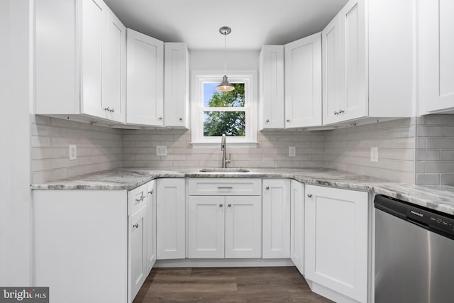 kitchen featuring pendant lighting, sink, dishwasher, light stone countertops, and white cabinets