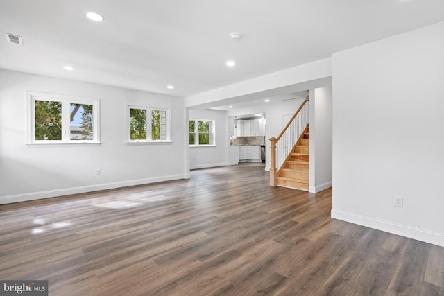 unfurnished living room featuring dark hardwood / wood-style floors