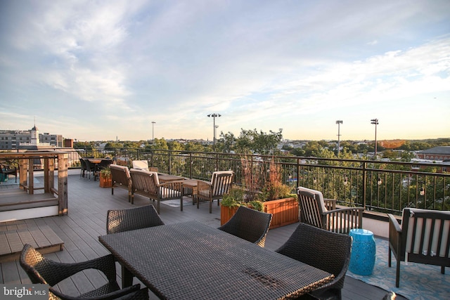 deck at dusk featuring an outdoor hangout area