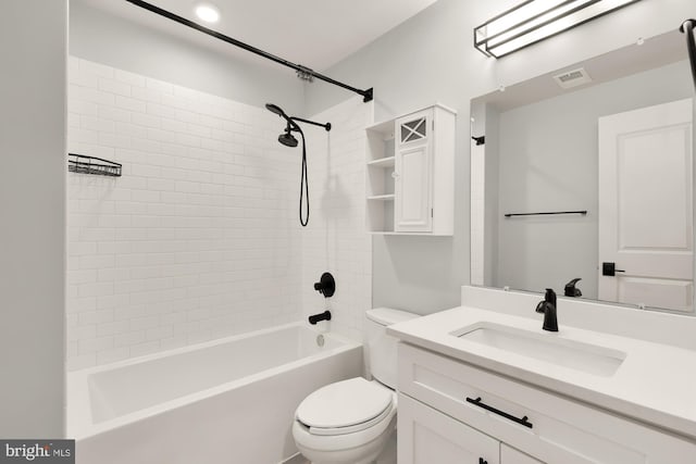 full bathroom featuring toilet, vanity, and tiled shower / bath