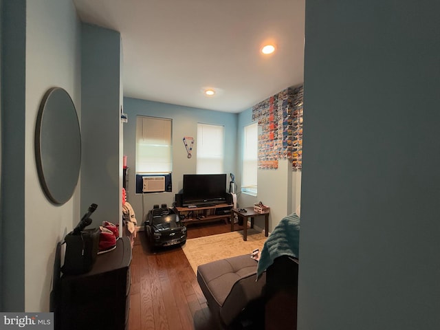 living room featuring wood-type flooring and cooling unit