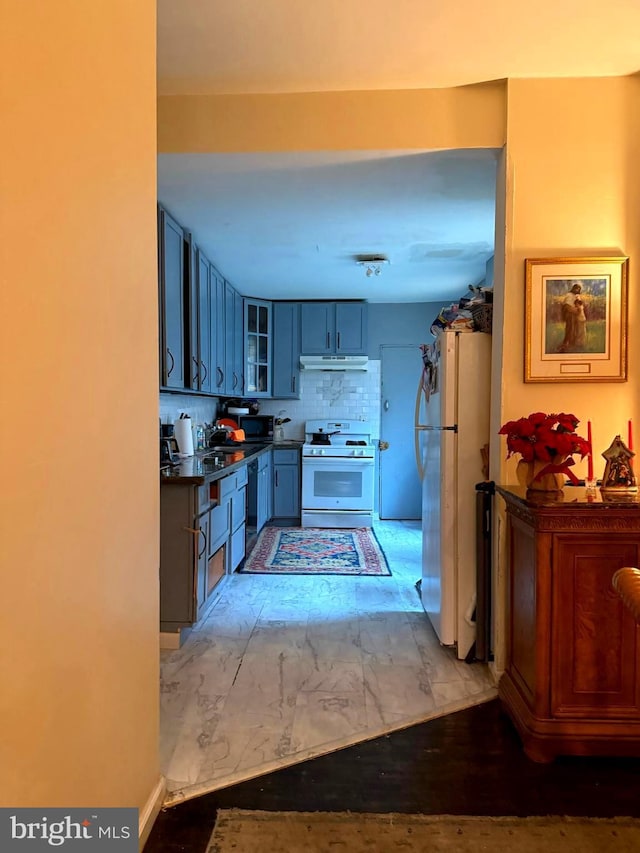 kitchen featuring gray cabinetry, sink, white appliances, and tasteful backsplash