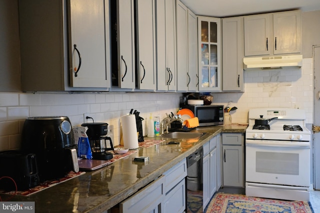 kitchen with sink, white gas range oven, black dishwasher, tasteful backsplash, and stone countertops